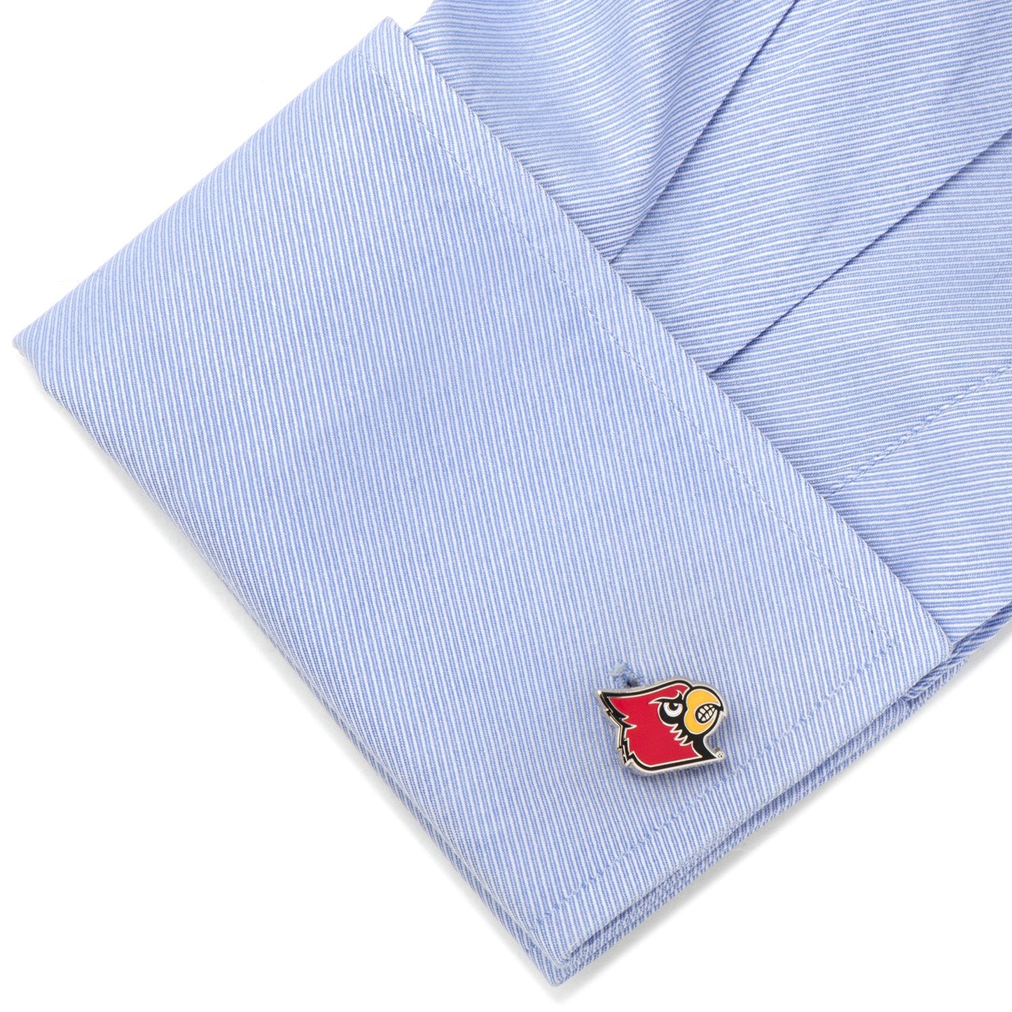 Cufflink with a red and yellow design on a light blue striped shirt