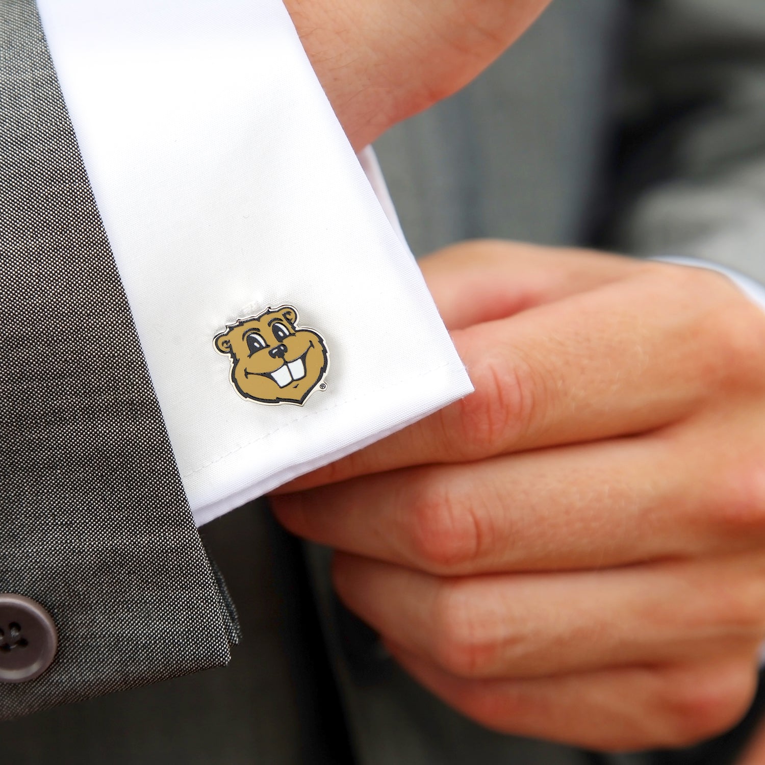 NCAA Minnesota Gophers Mascot Cufflink with a cartoon bear design on a white shirt cuff.