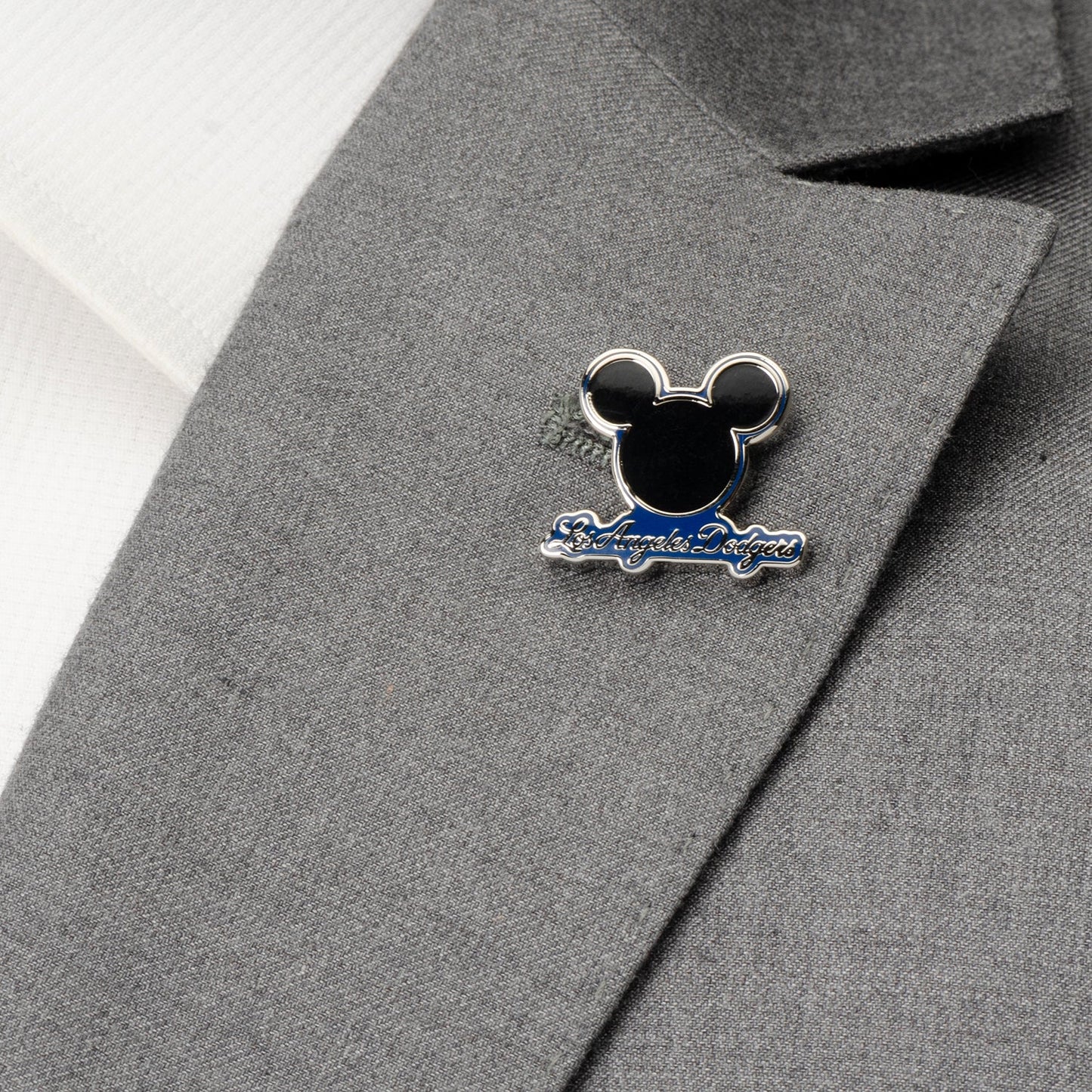 Pin with a design on a gray suit jacket