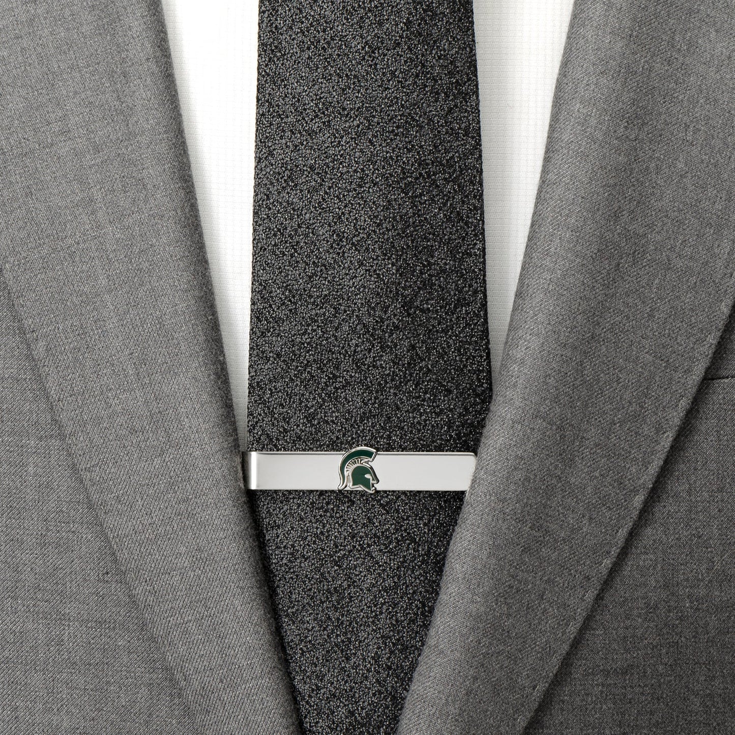 Gray textured tie with a silver clasp on a gray suit jacket