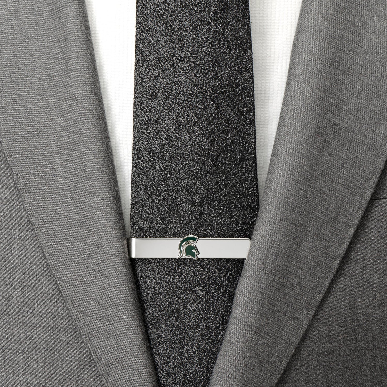 Gray textured tie with a silver clasp on a gray suit jacket