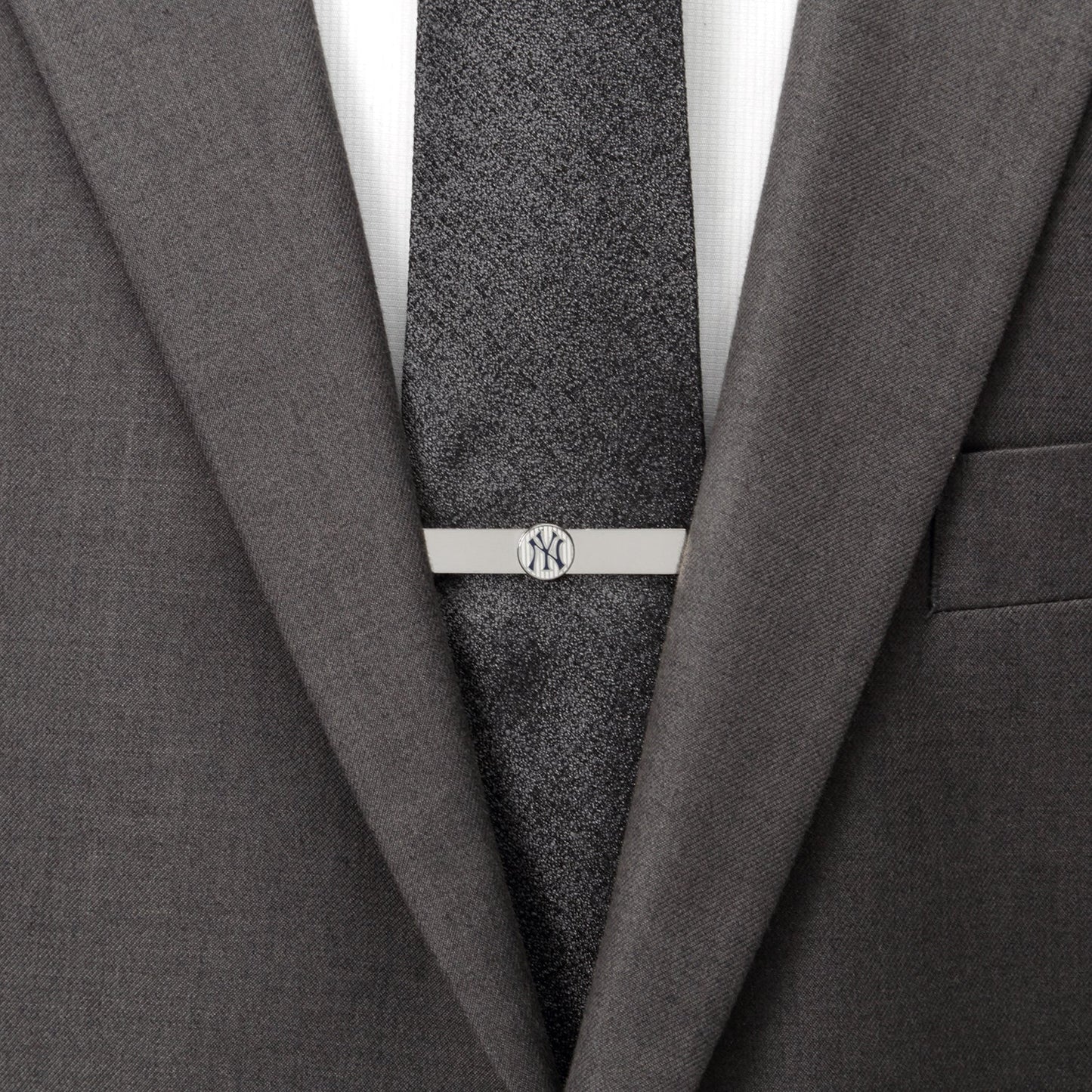 Gray suit with a tie and silver tie clip on a white background