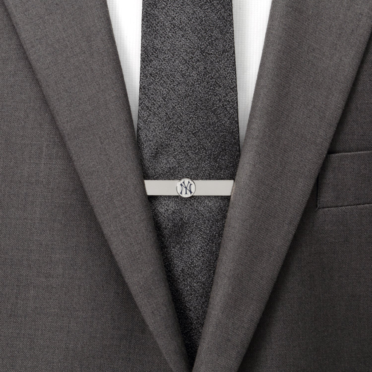 Gray suit with a tie and silver tie clip on a white background