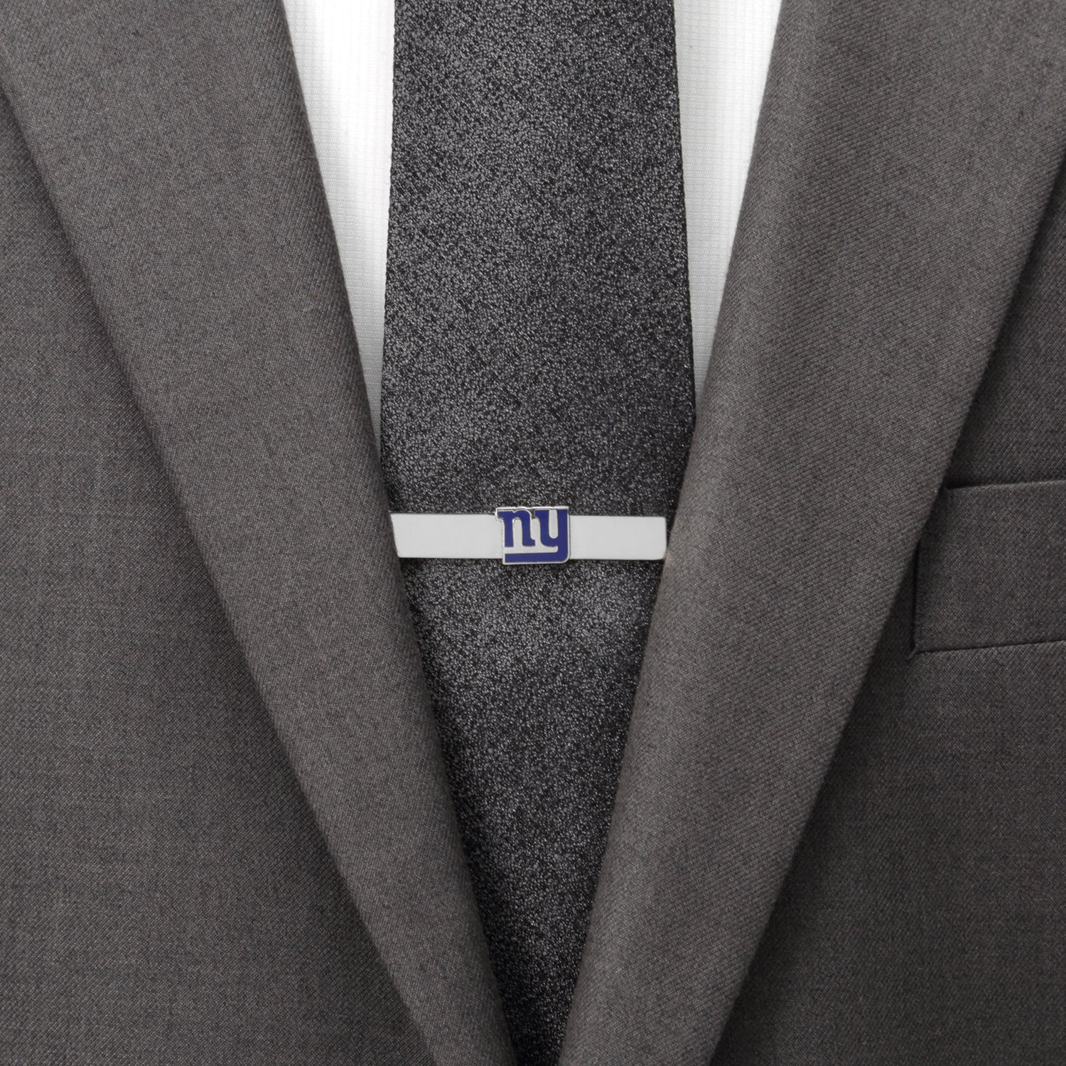 Gray suit jacket with a gray tie and a tie clip on a white background