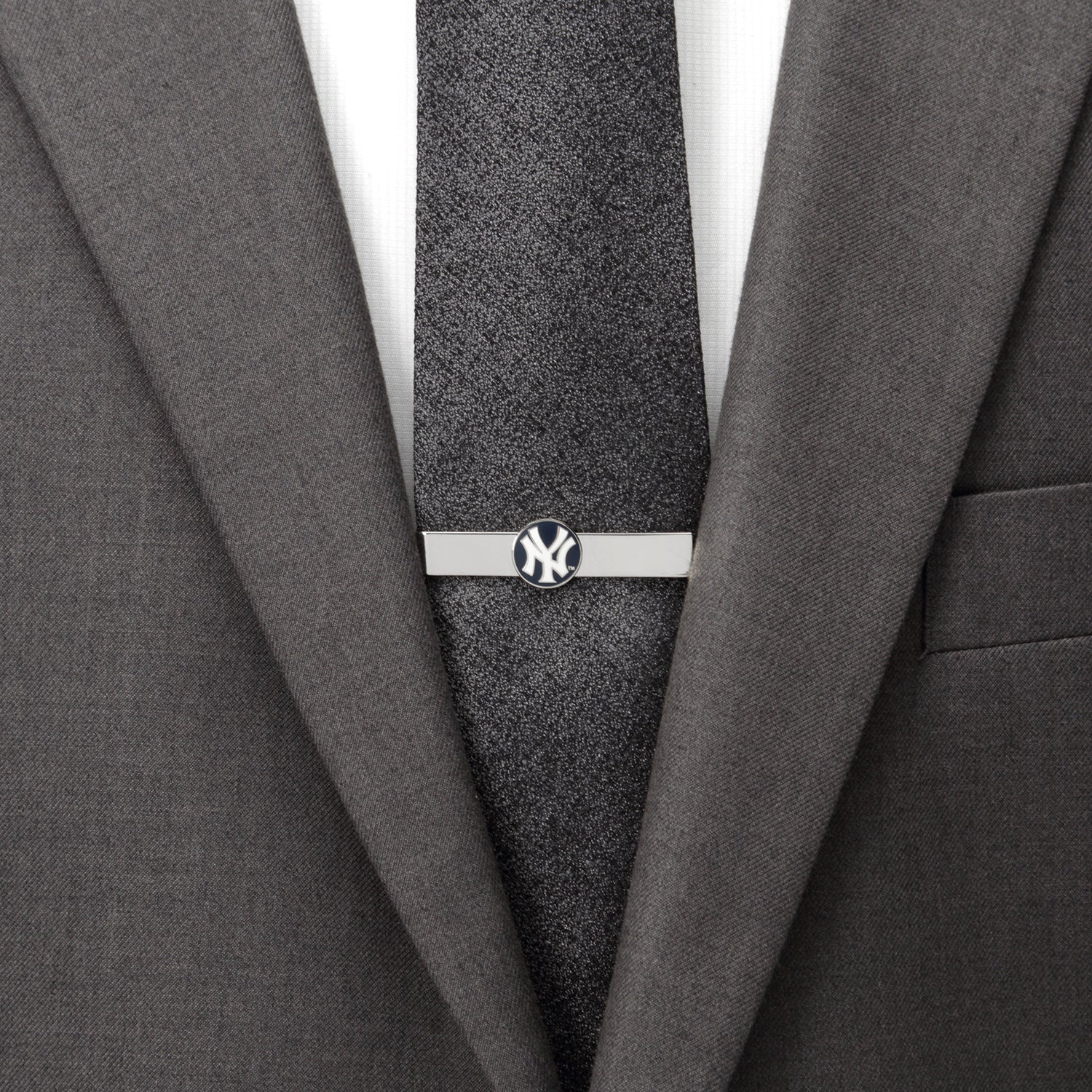 Gray suit with a tie and tie clip on a white background