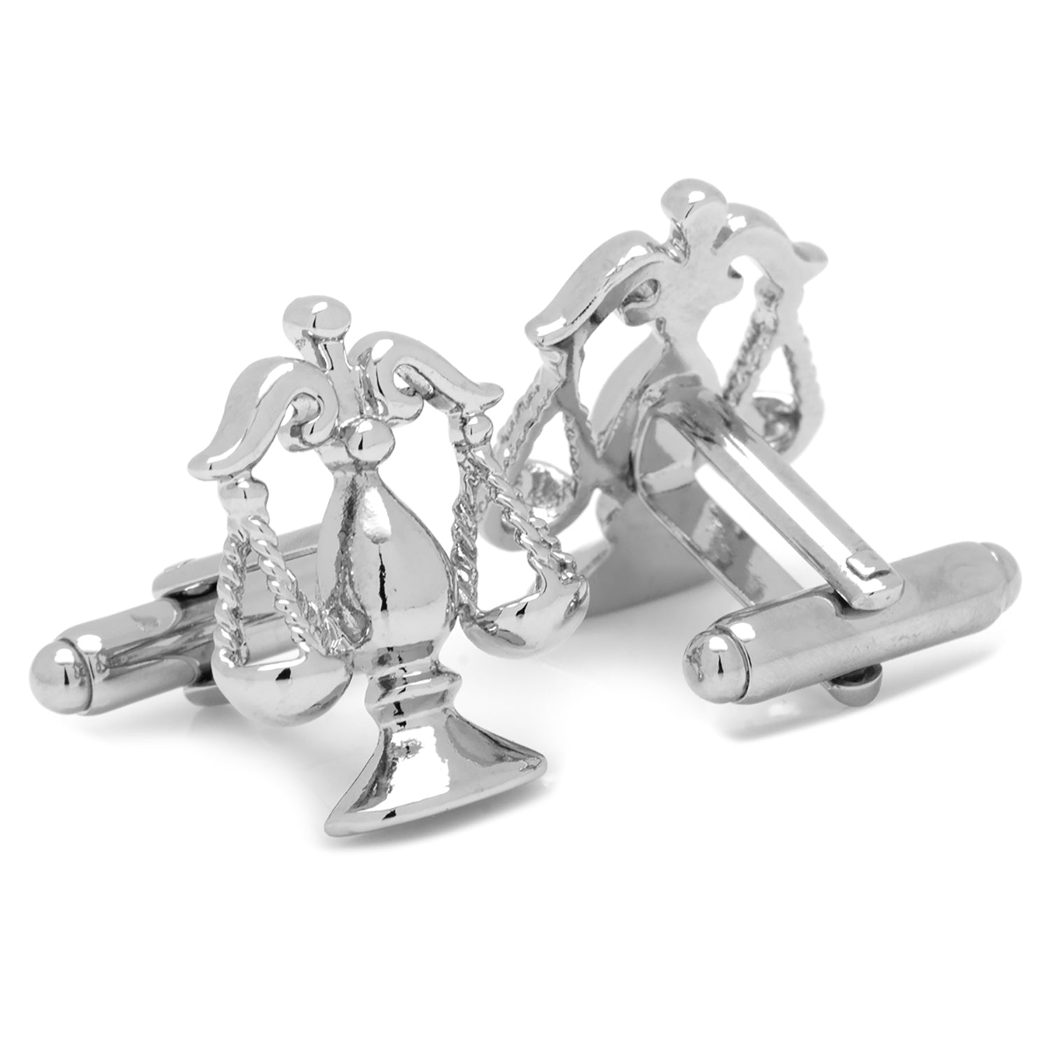 Silver cufflinks with intricate design on a white background