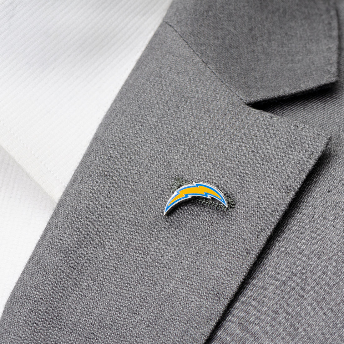 Gray suit jacket with a sports team logo pin on the lapel NFL Los Angeles Chargers Lapel Pin
