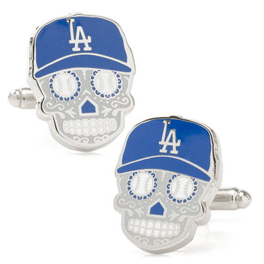Skull-shaped cufflinks with blue baseball cap and LA logo on a white background