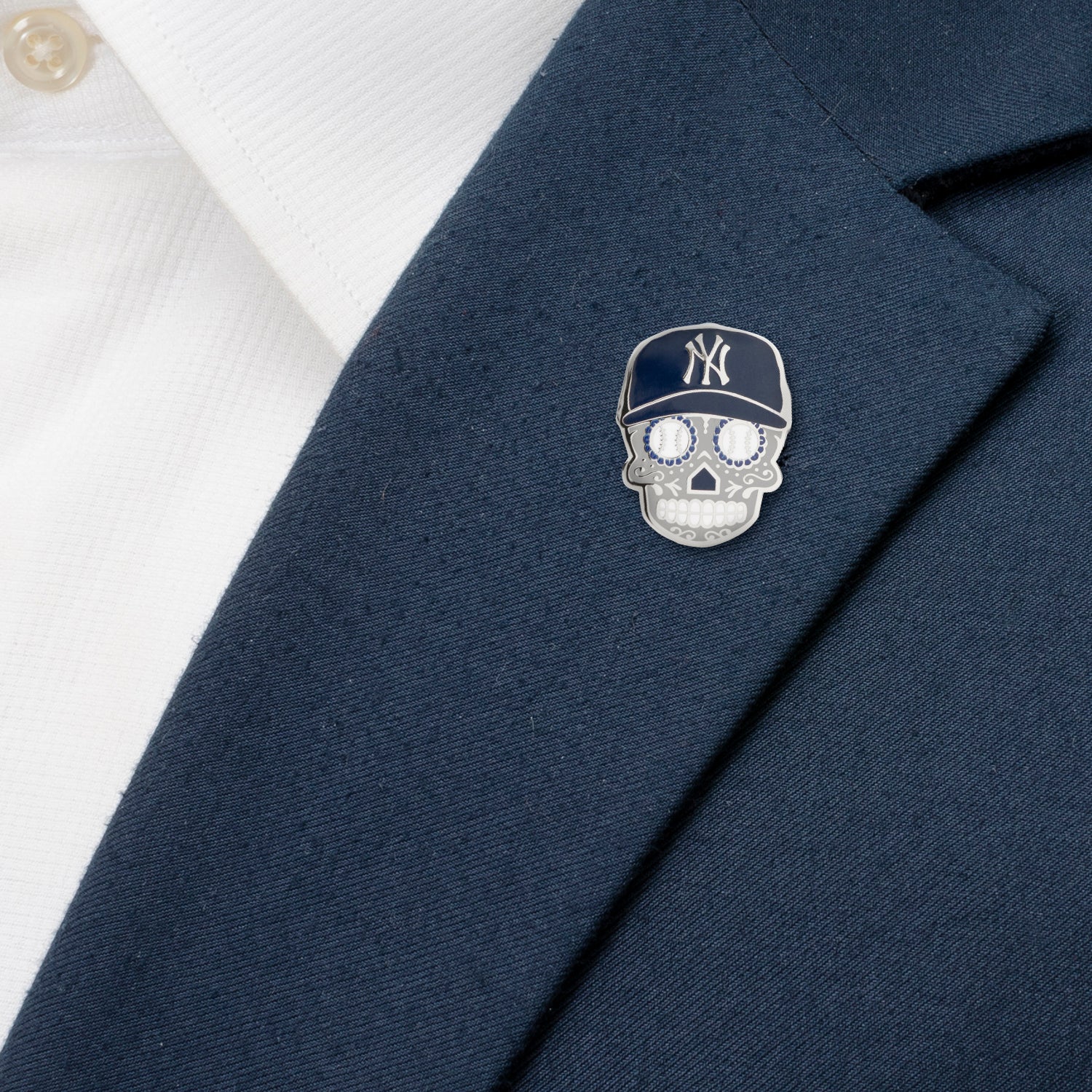 Skull-shaped pin with a cap on a navy blazer
