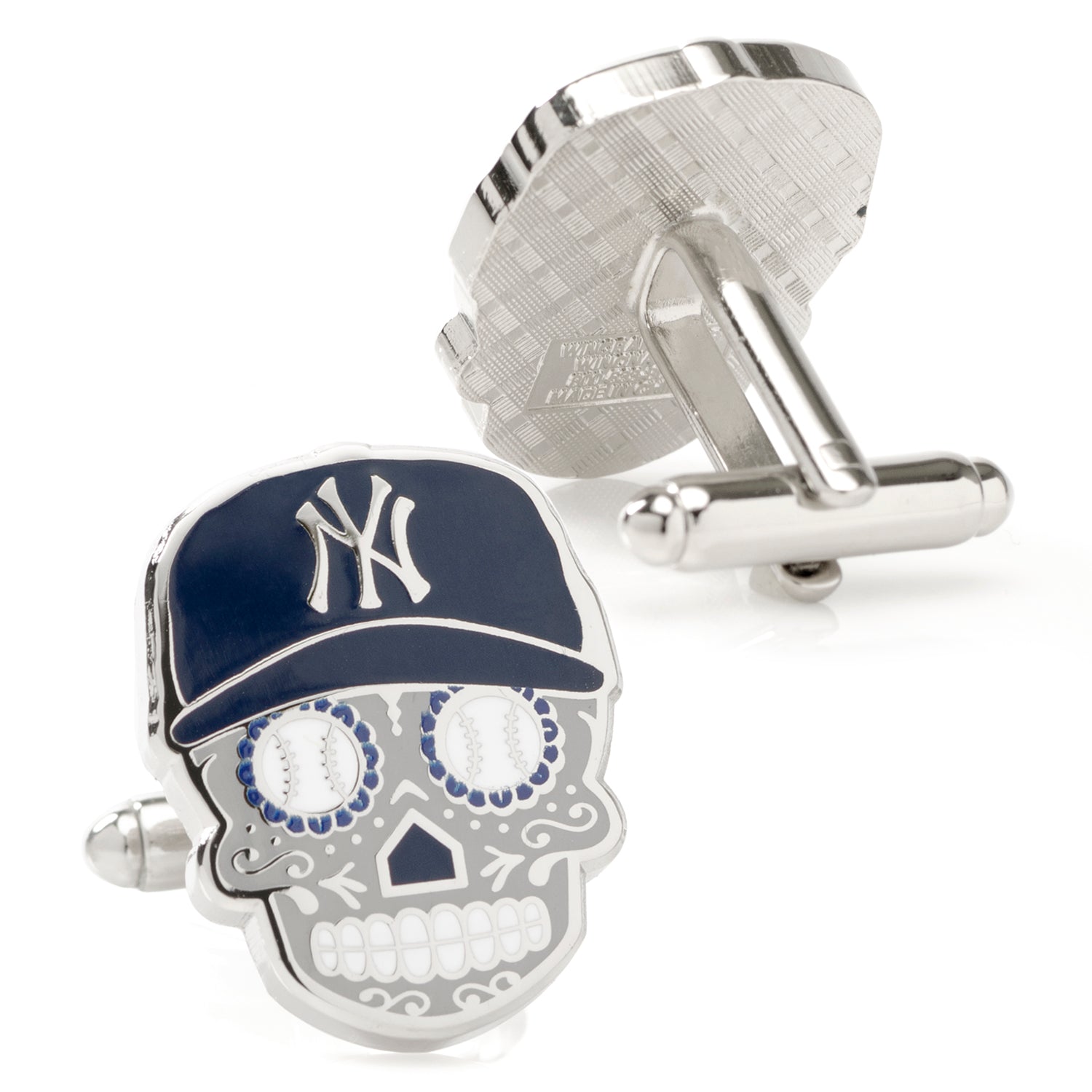 Cufflinks with skull design and New York Yankees cap on a white background