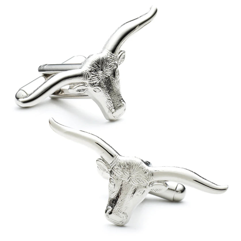 Silver bull head cufflinks on a white background