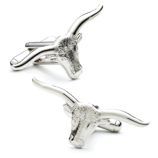 Silver bull head cufflinks on a white background