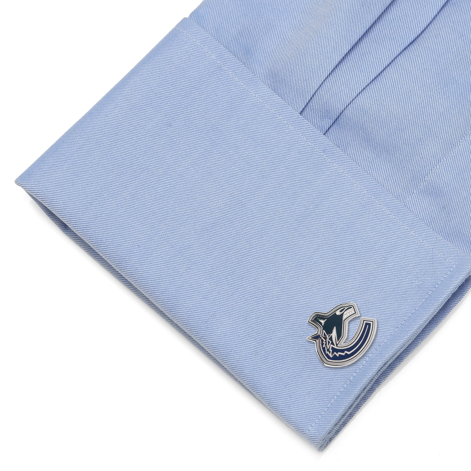 Cufflink on a light blue dress shirt
