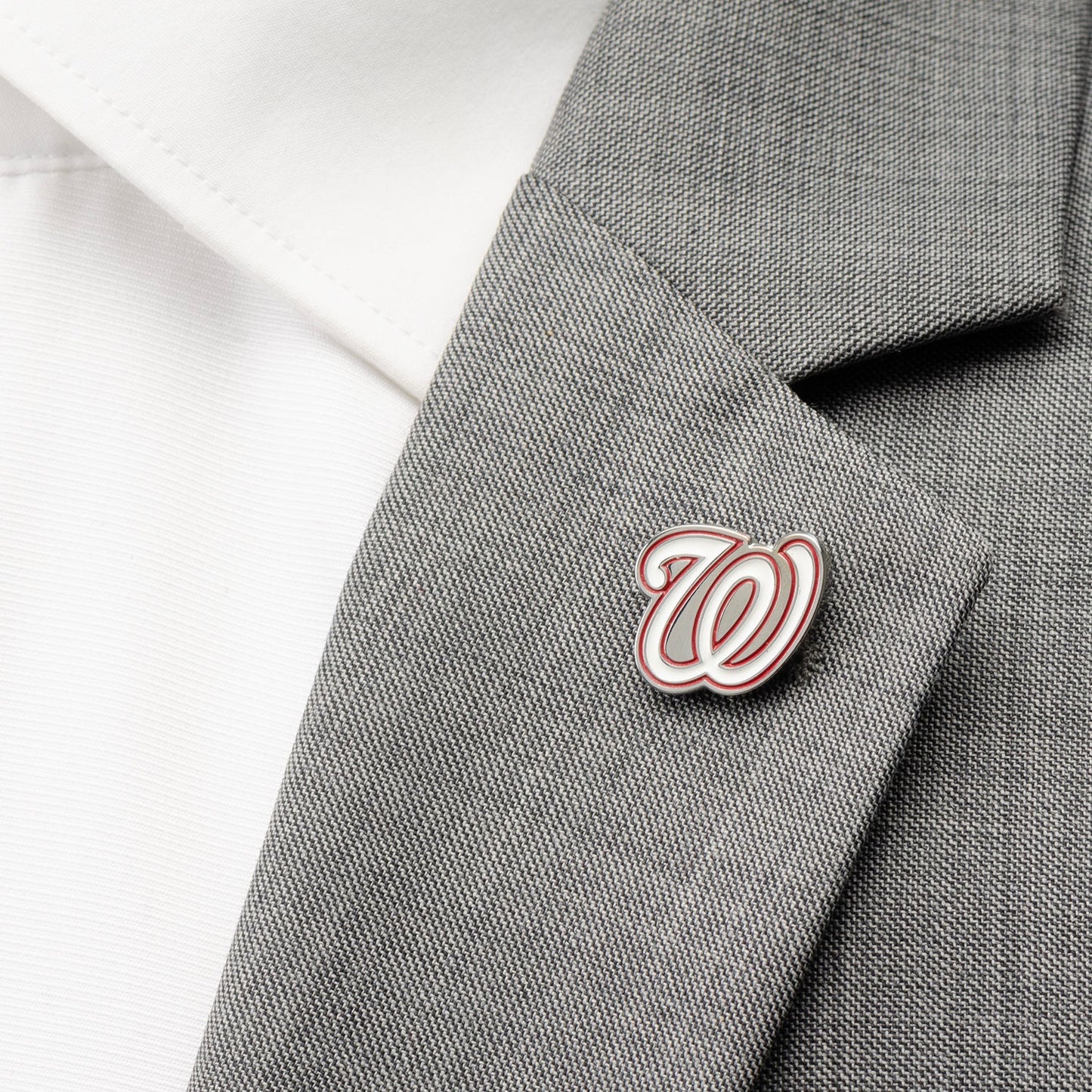 Pin with a logo on a gray suit jacket