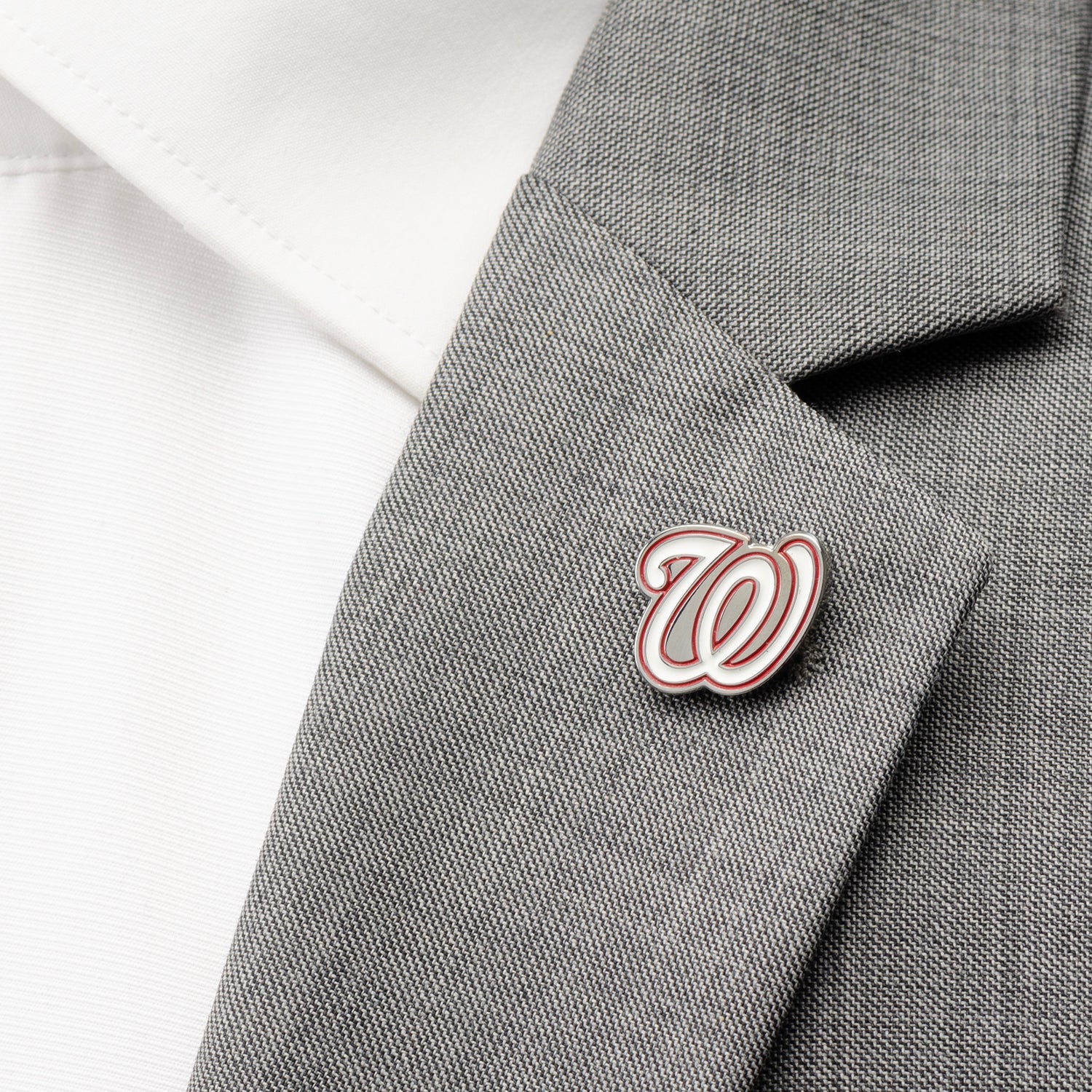 Pin with a logo on a gray suit jacket