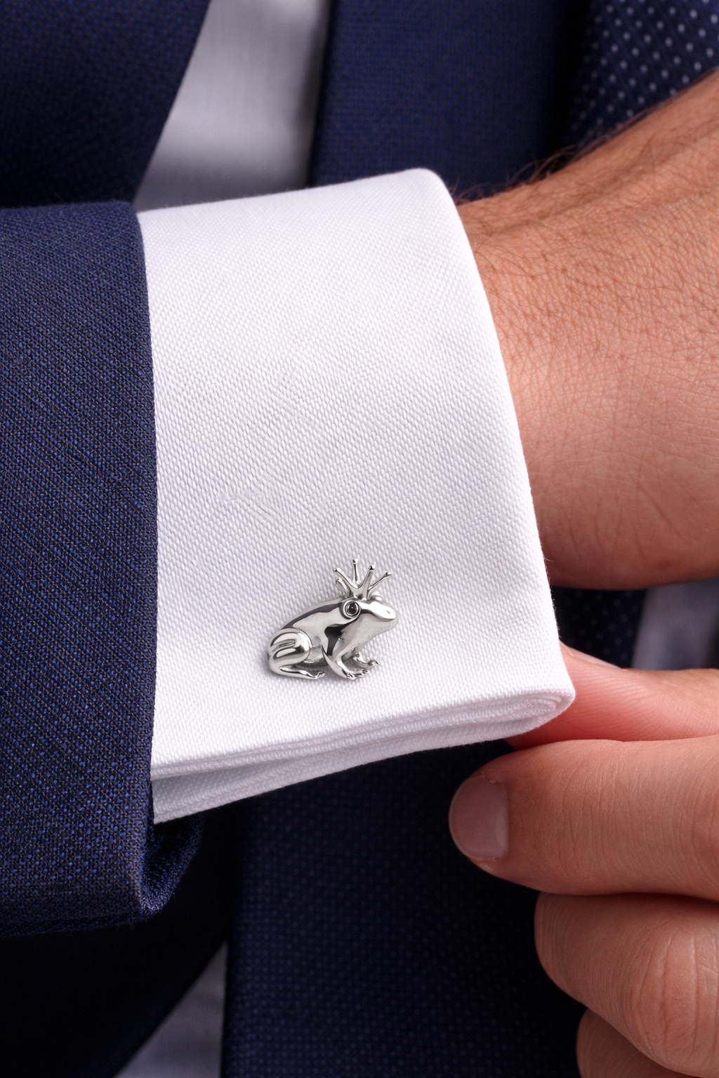 Prince charming frog cufflinks with silver crown on a cuff of a dark suit with a white shirt