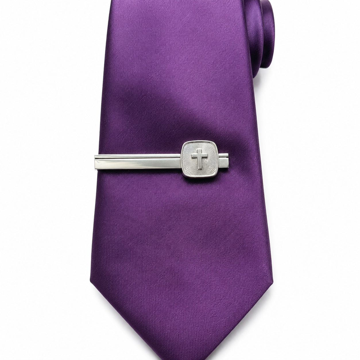 Purple tie with a silver cross tie clip featuring a cross on a white background