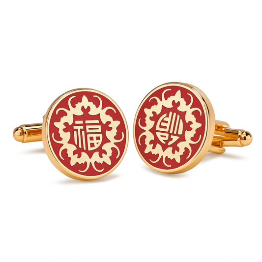 Red and gold cufflinks with intricate designs on a white background