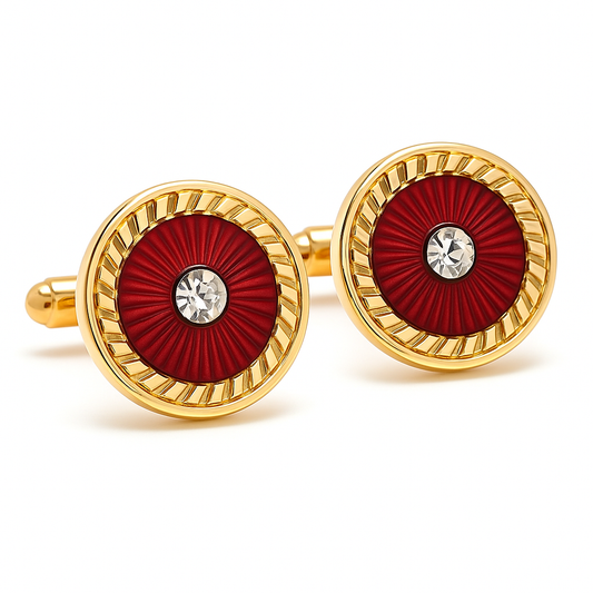Gold cufflinks with red circular design and central gemstone on a white background