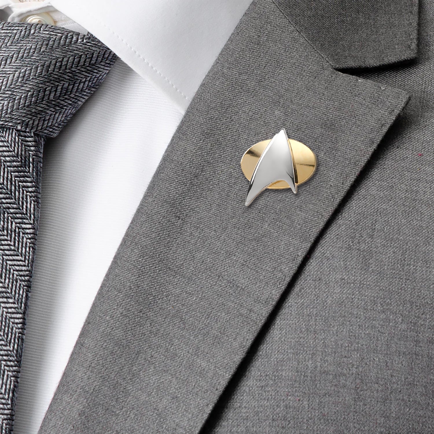 Star Trek badge on a gray suit jacket with a tie 