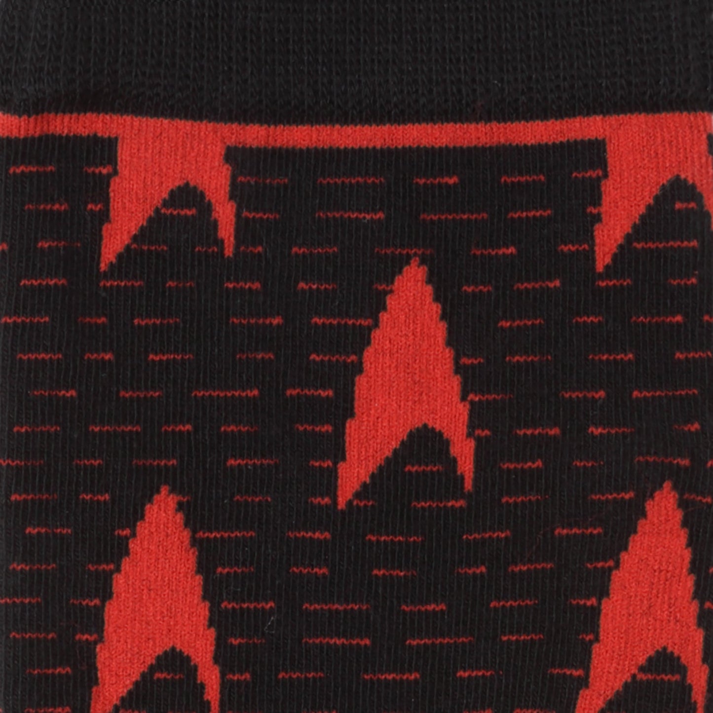 Close-up of black socks with red geometric pattern