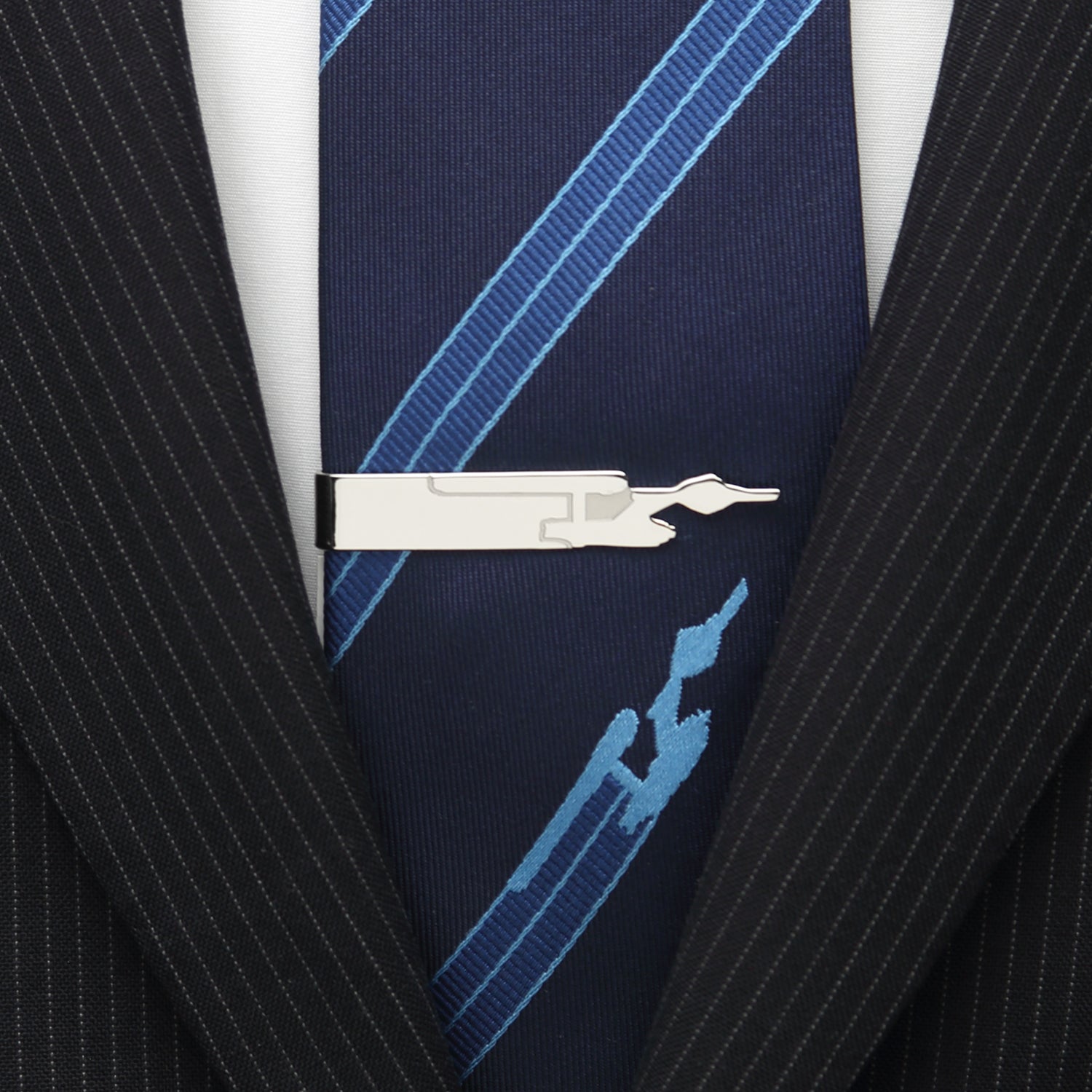 Navy blue tie with blue geometric pattern worn with a black pinstripe suit jacket. Star Trek Enterprise Silhouette Tie Bar