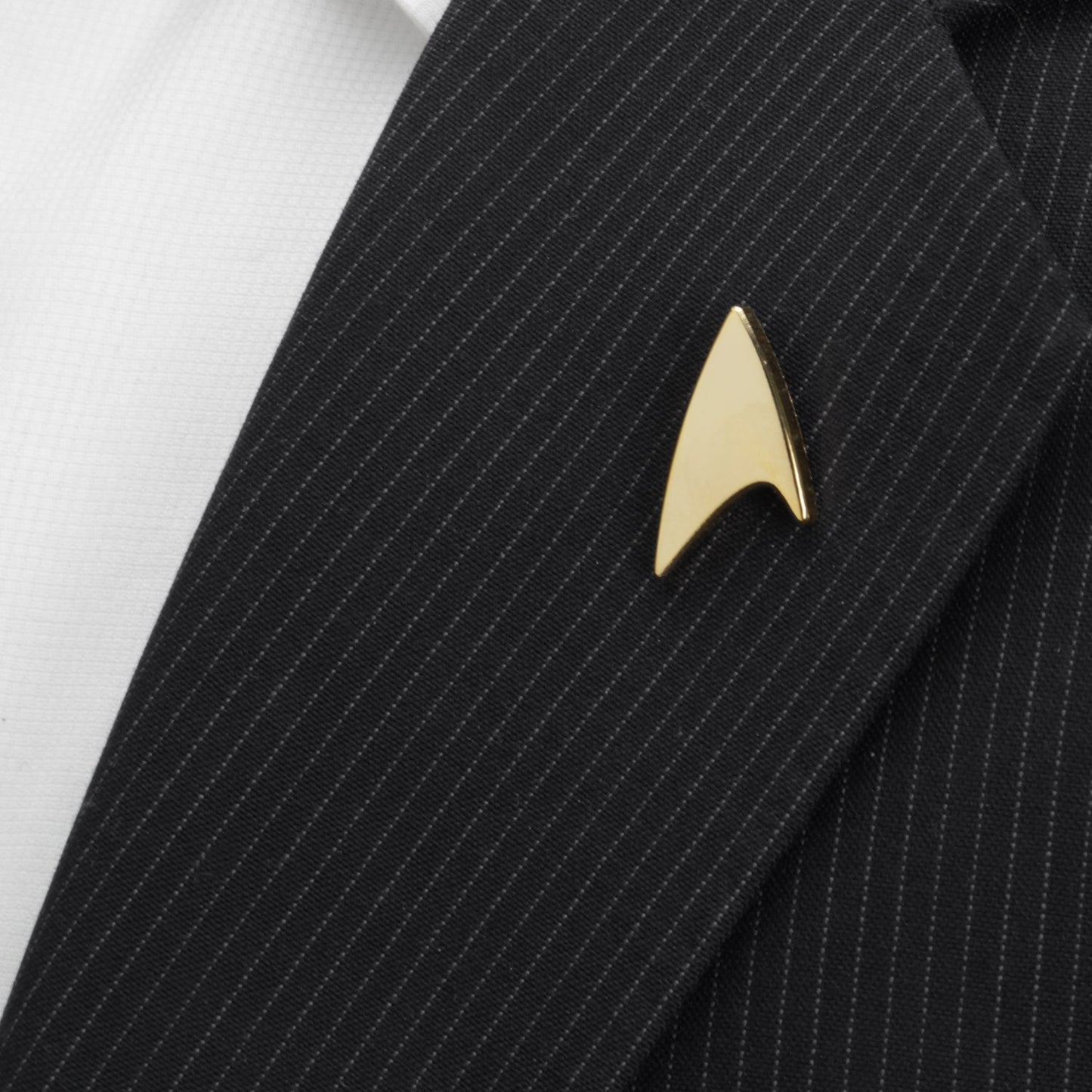 Star Trek Gold Delta Shield Lapel Pin Gold Star Trek logo pin on a black pinstripe suit jacket