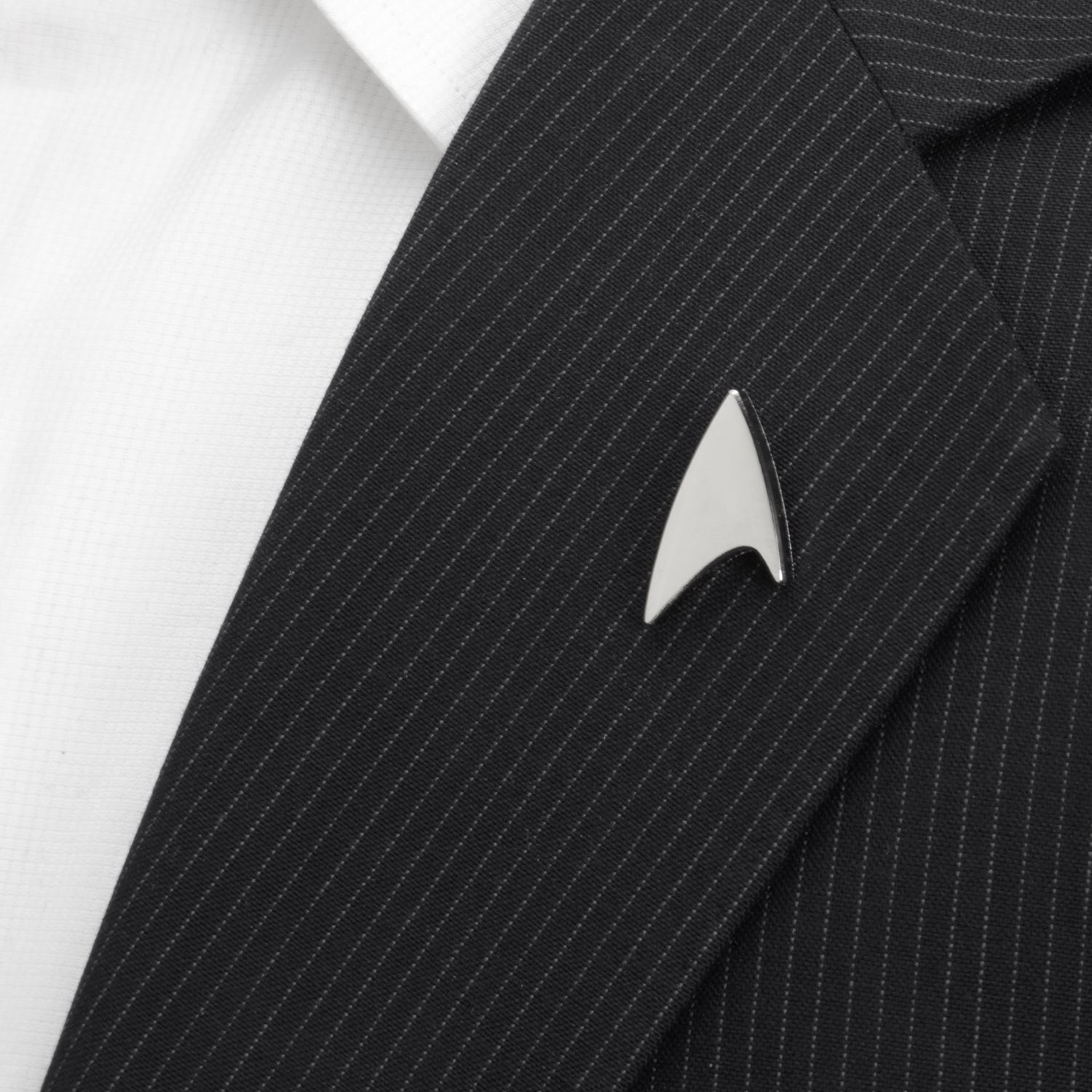 Black pinstripe suit with a silver Star Trek uniform badge on a white background