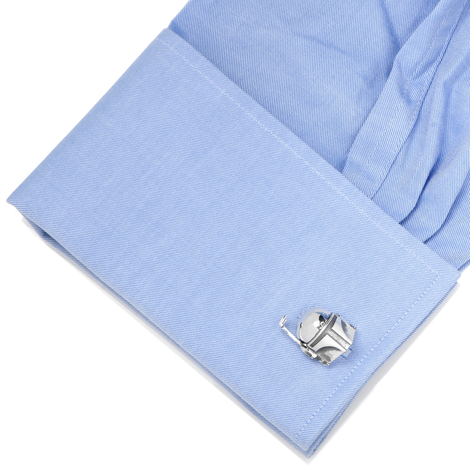Close-up of a light blue shirt cuff with a silver cufflink on a white background