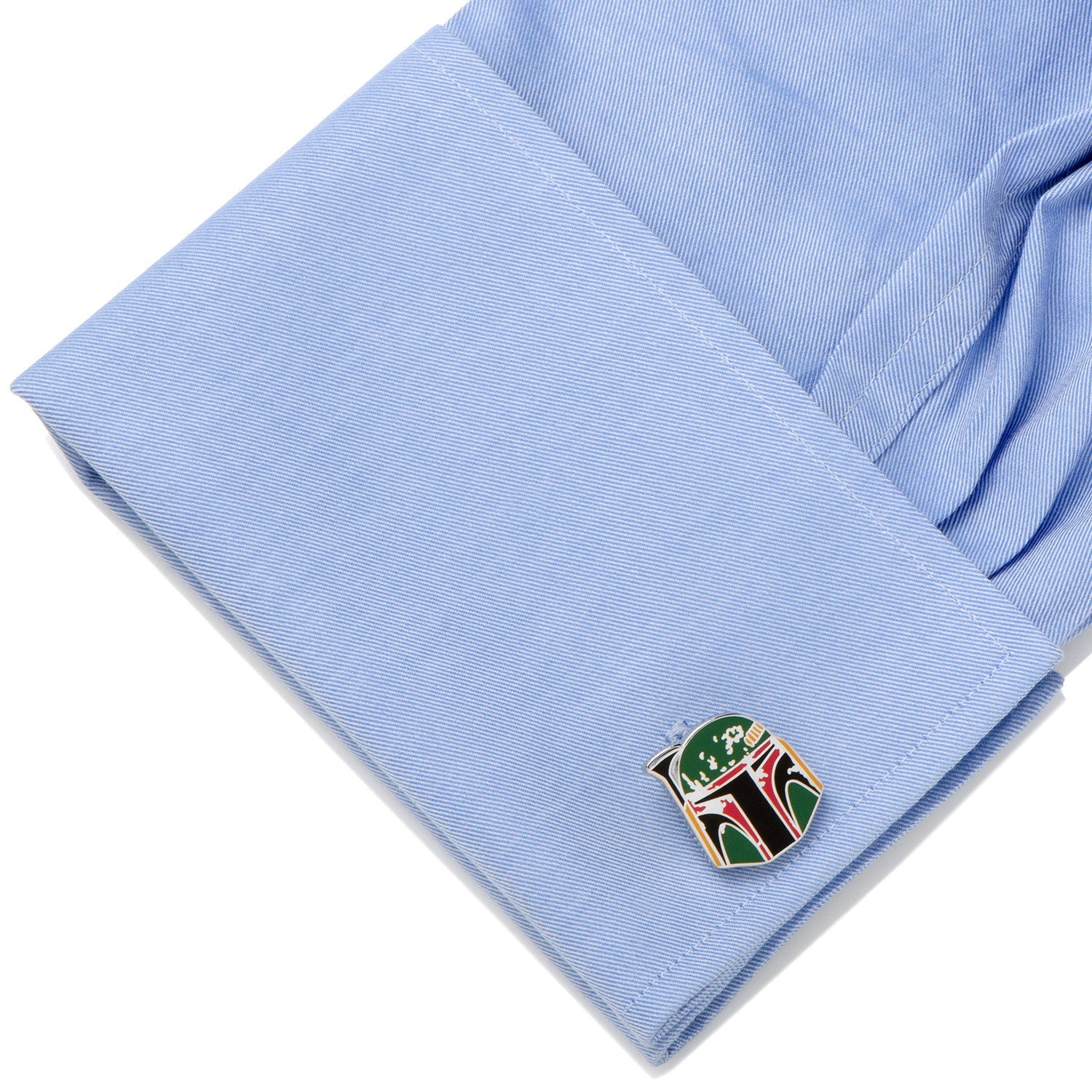 Cufflink with a distinctive design on a light blue shirt