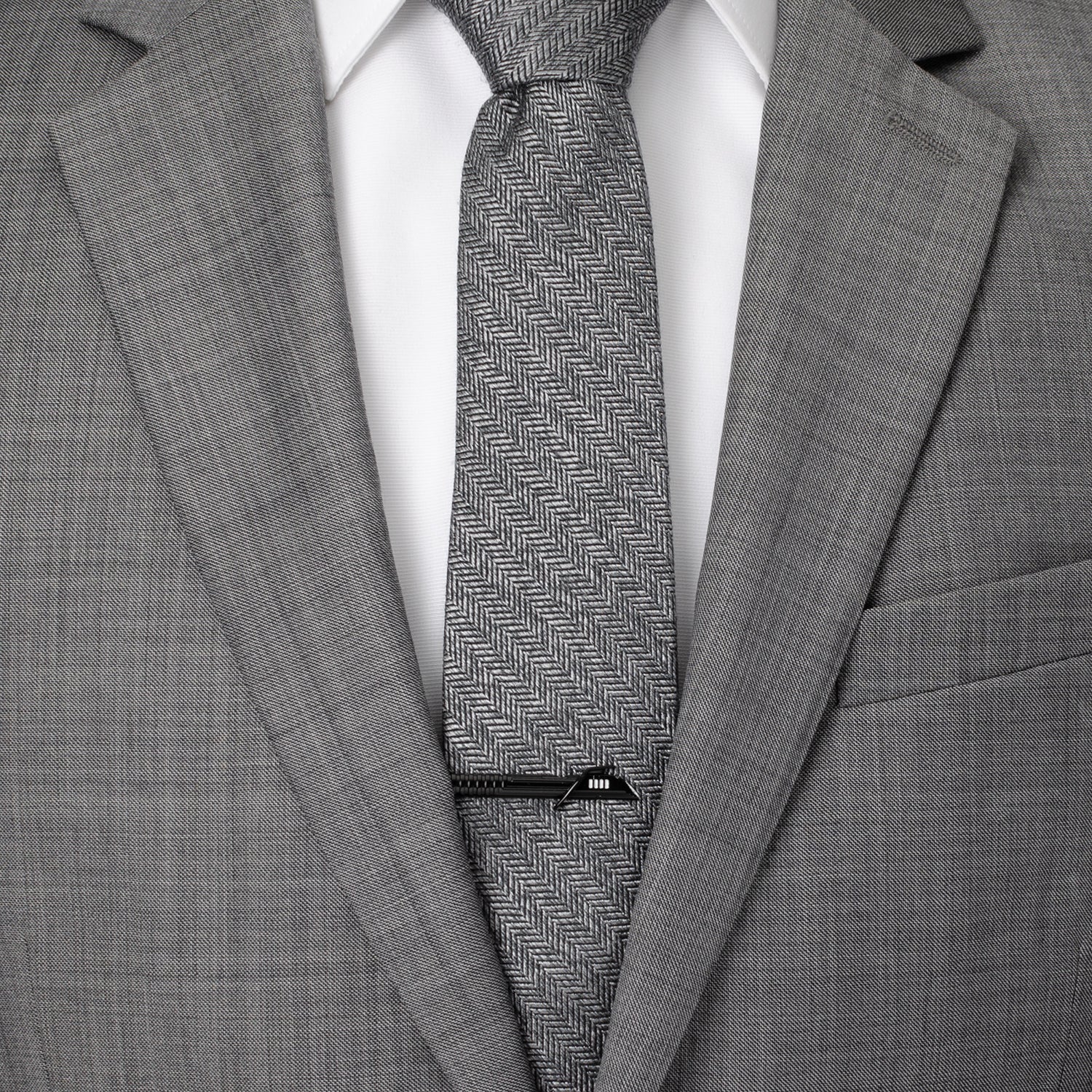 Gray suit with a patterned tie and visible brand label.