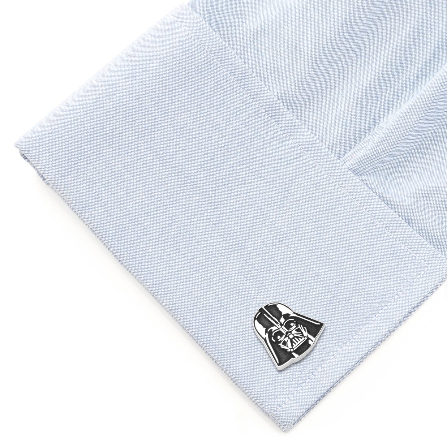 Cufflink shaped like Darth Vader on a light blue dress shirt