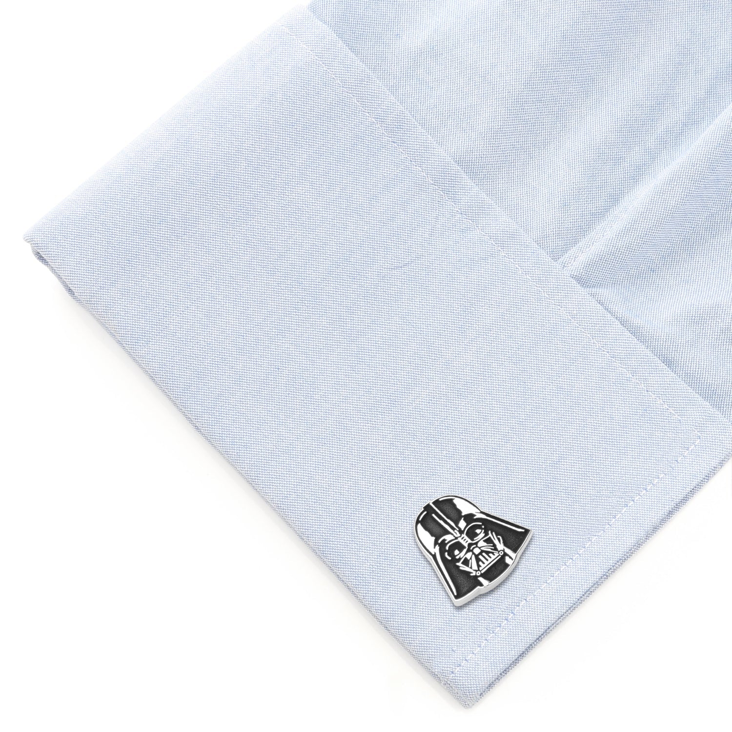 Cufflink shaped like Darth Vader on a light blue dress shirt