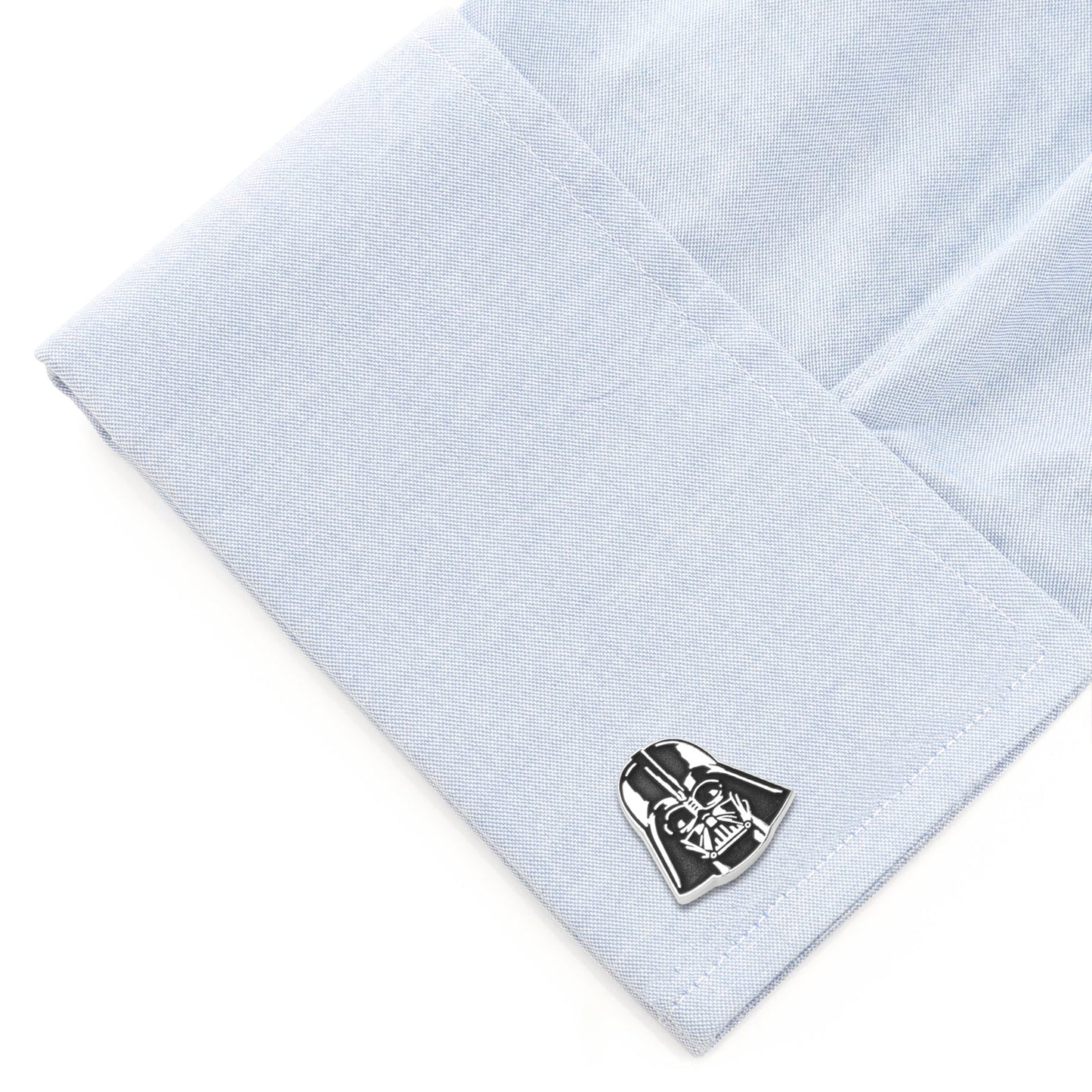 Cufflink shaped like Darth Vader's helmet on a light blue shirt