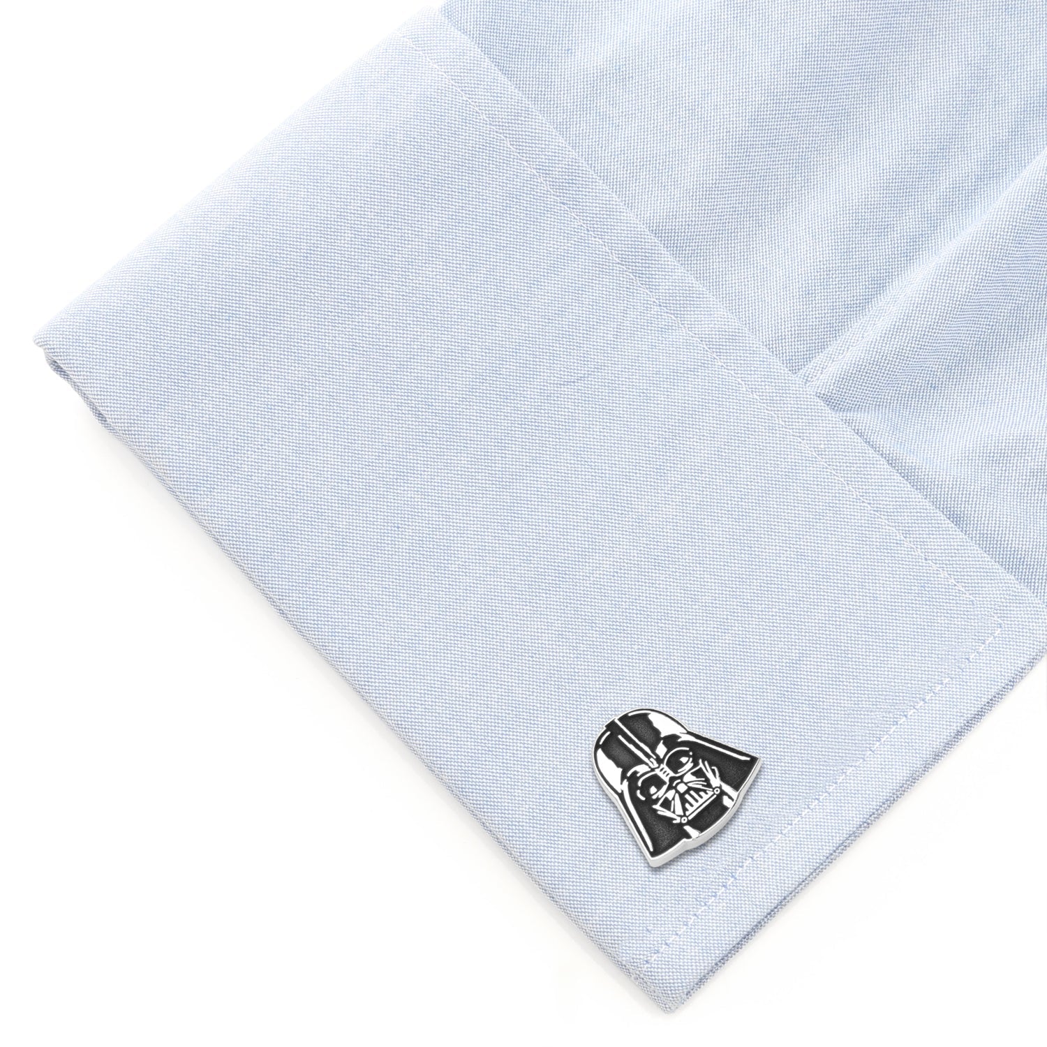Cufflink shaped like Darth Vader's helmet on a light blue shirt