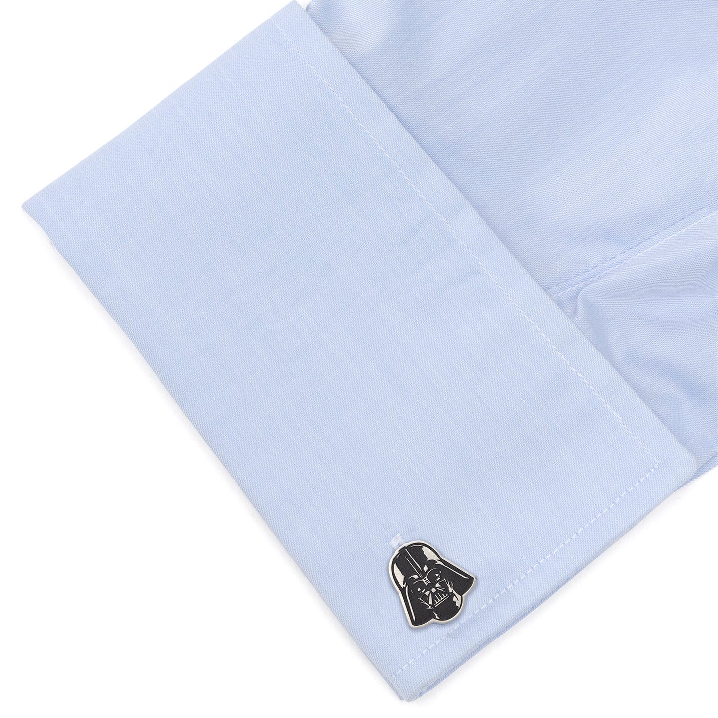 Cufflink with a Darth Vader design on light blue dress shirt