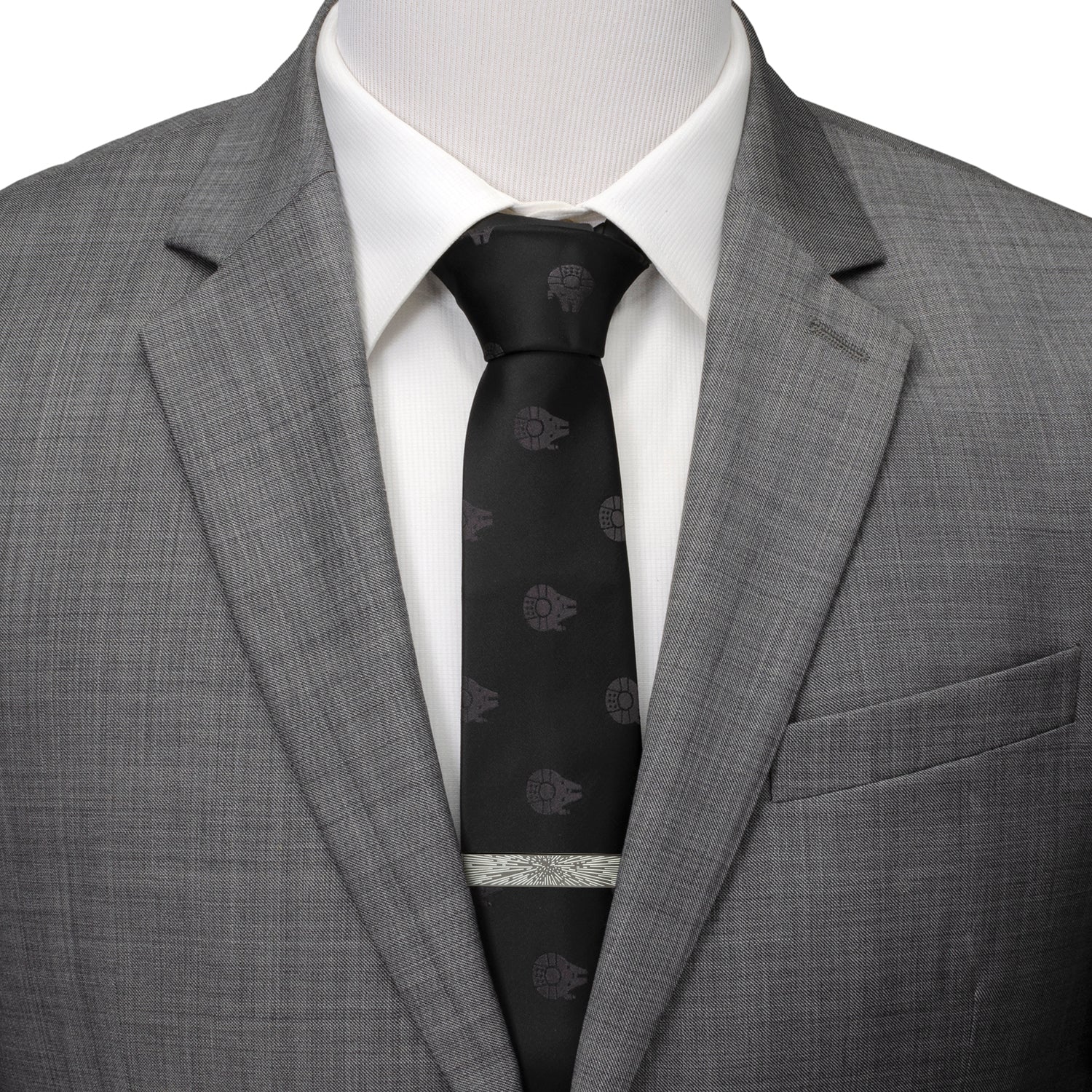 Gray suit jacket with a white shirt and black tie on a mannequin.