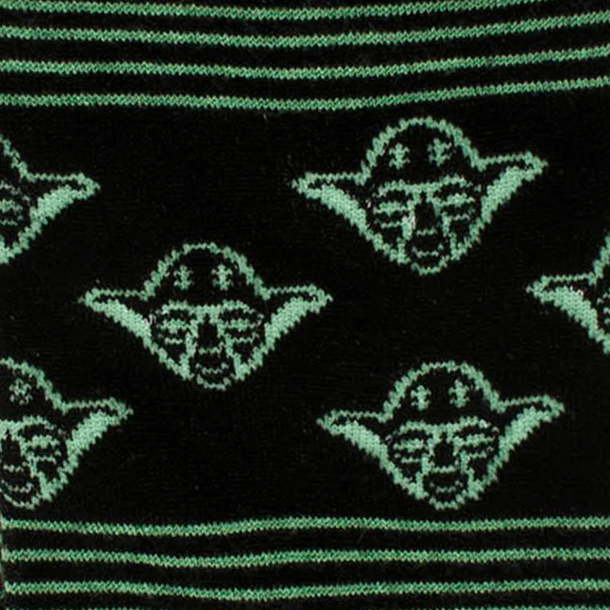 Pattern of a character's face with green outlines on black fabric.