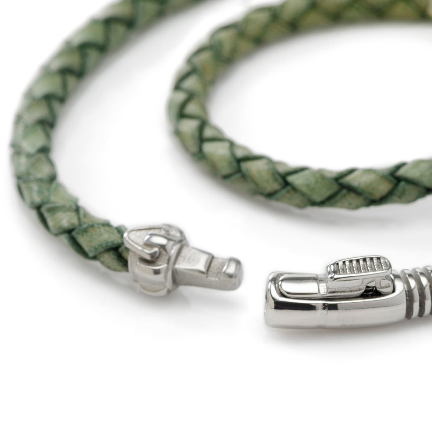 Green braided leather bracelet with silver clasp on a white background