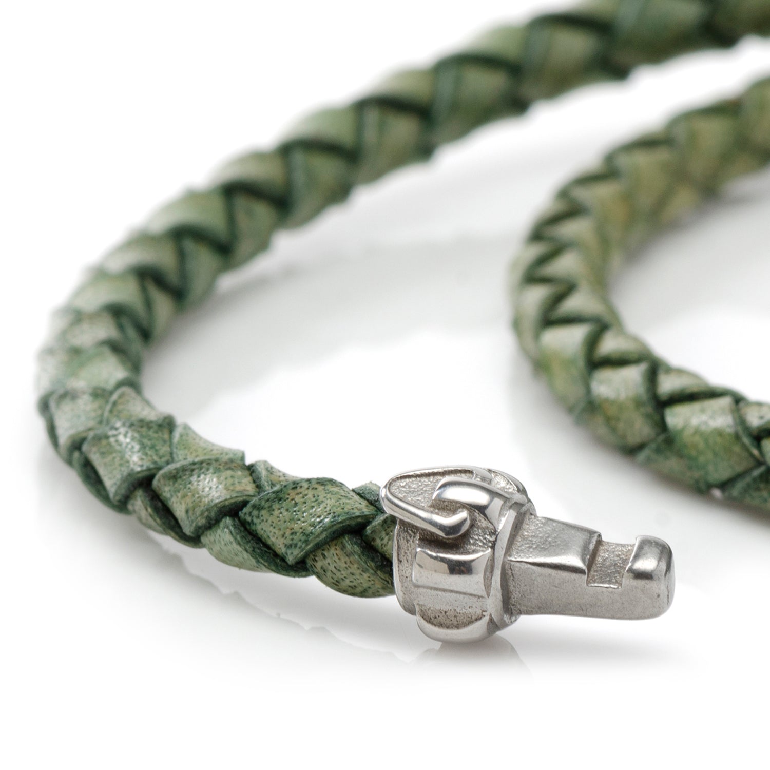 Green braided leather bracelet with a silver clasp on a white background