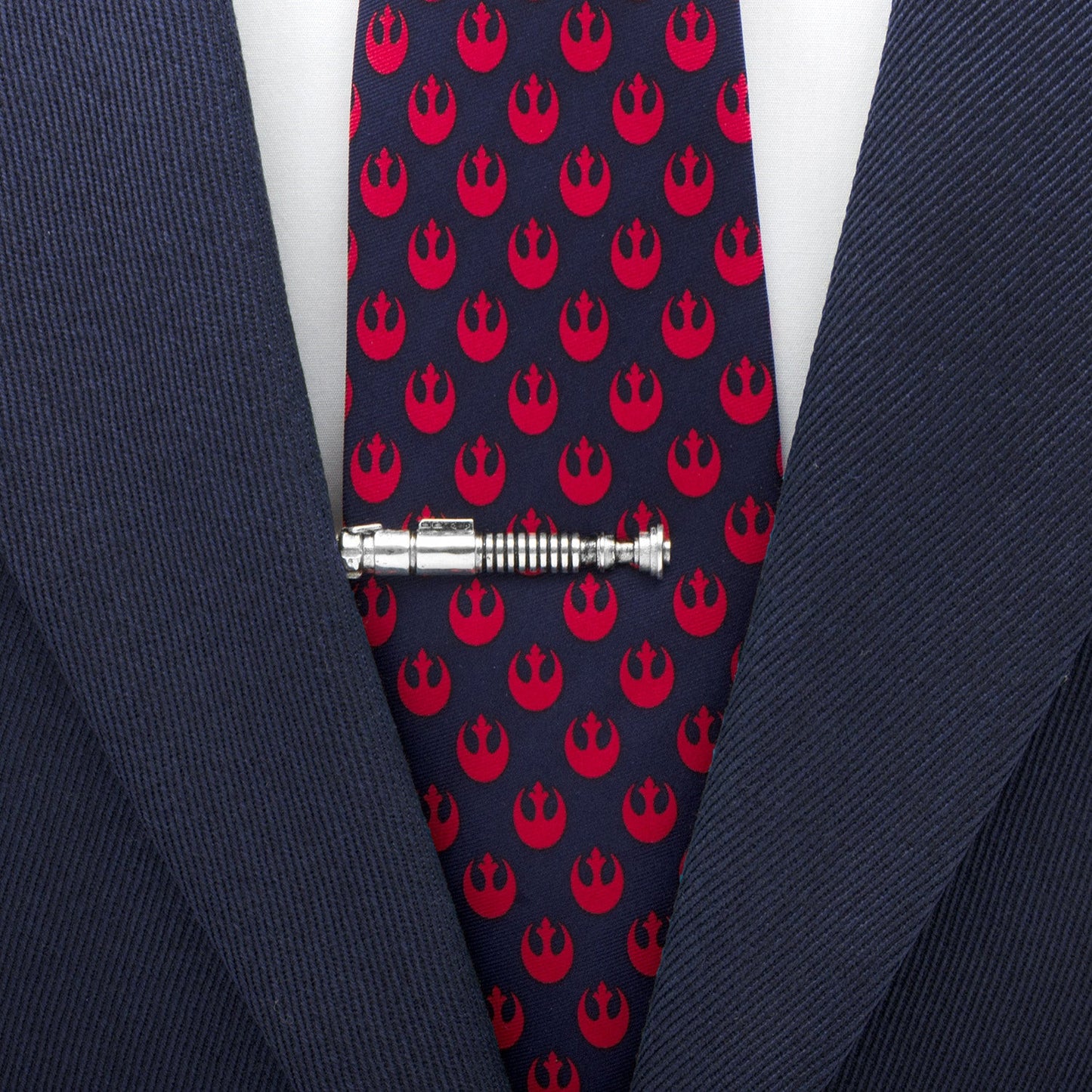 Navy tie with red Rebel Alliance symbols and a silver tie clip on a suit.