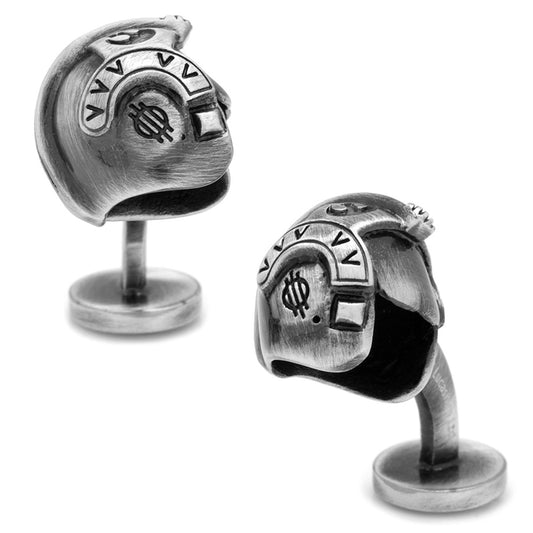 Pair of silver cufflinks with intricate designs on a white background