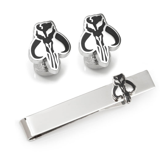 Silver skull-shaped cufflinks and tie clip on a white background