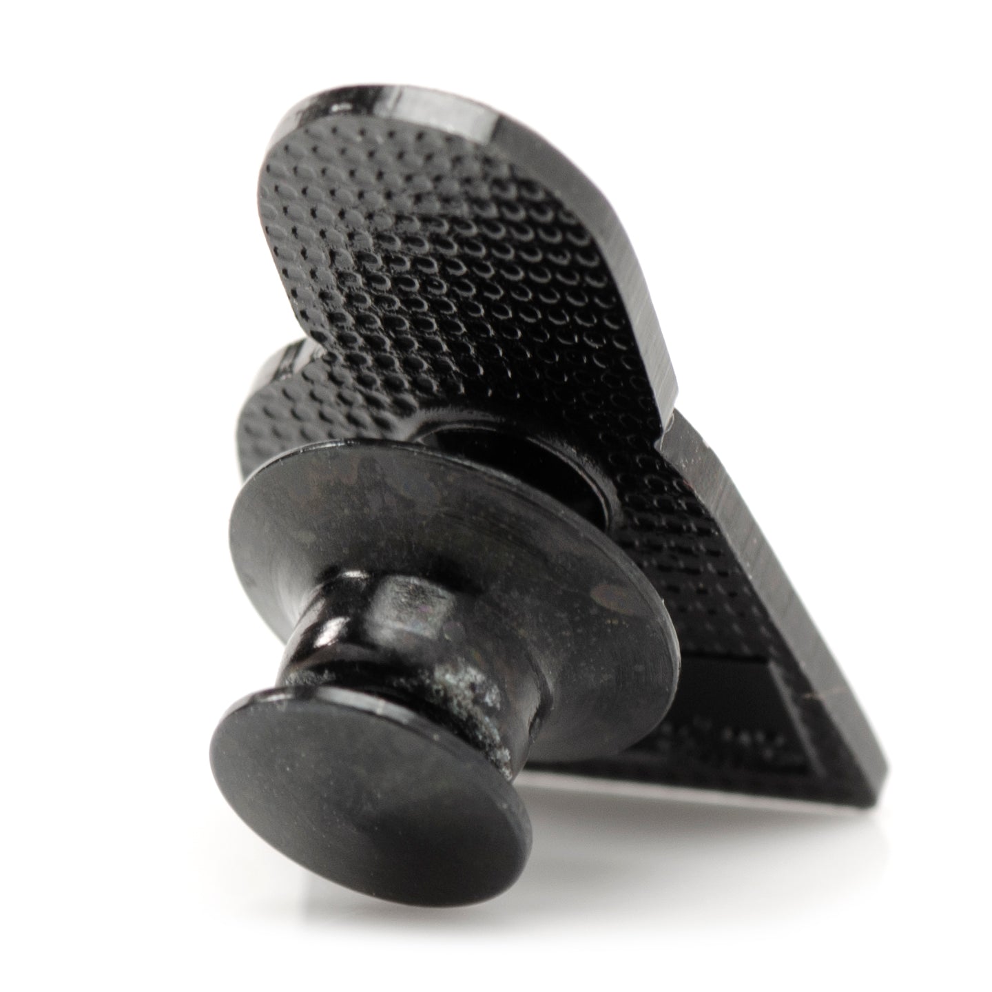 Black metal clip with textured surface on a white background