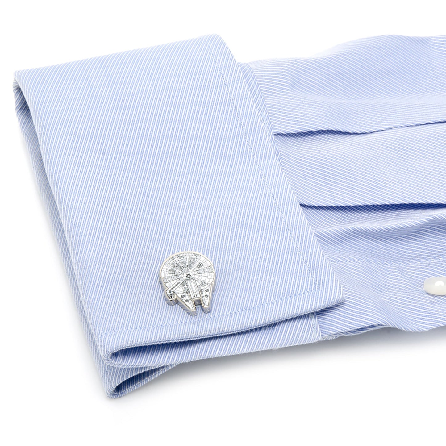 Cufflinks on a light blue dress shirt with a white background