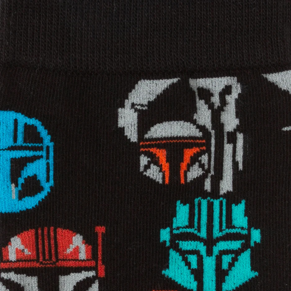 Black socks with pixelated designs of characters from a science fiction series on a black background.
