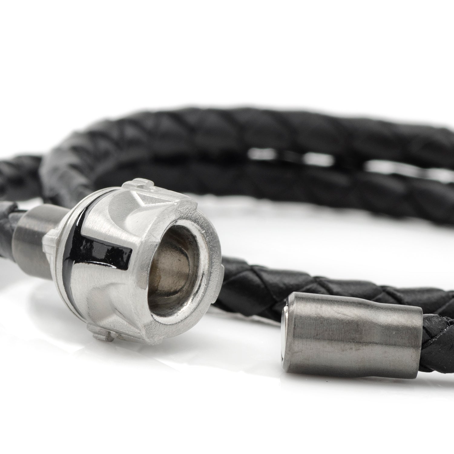 Close-up of a black braided leather bracelet with metal clasp on a white background