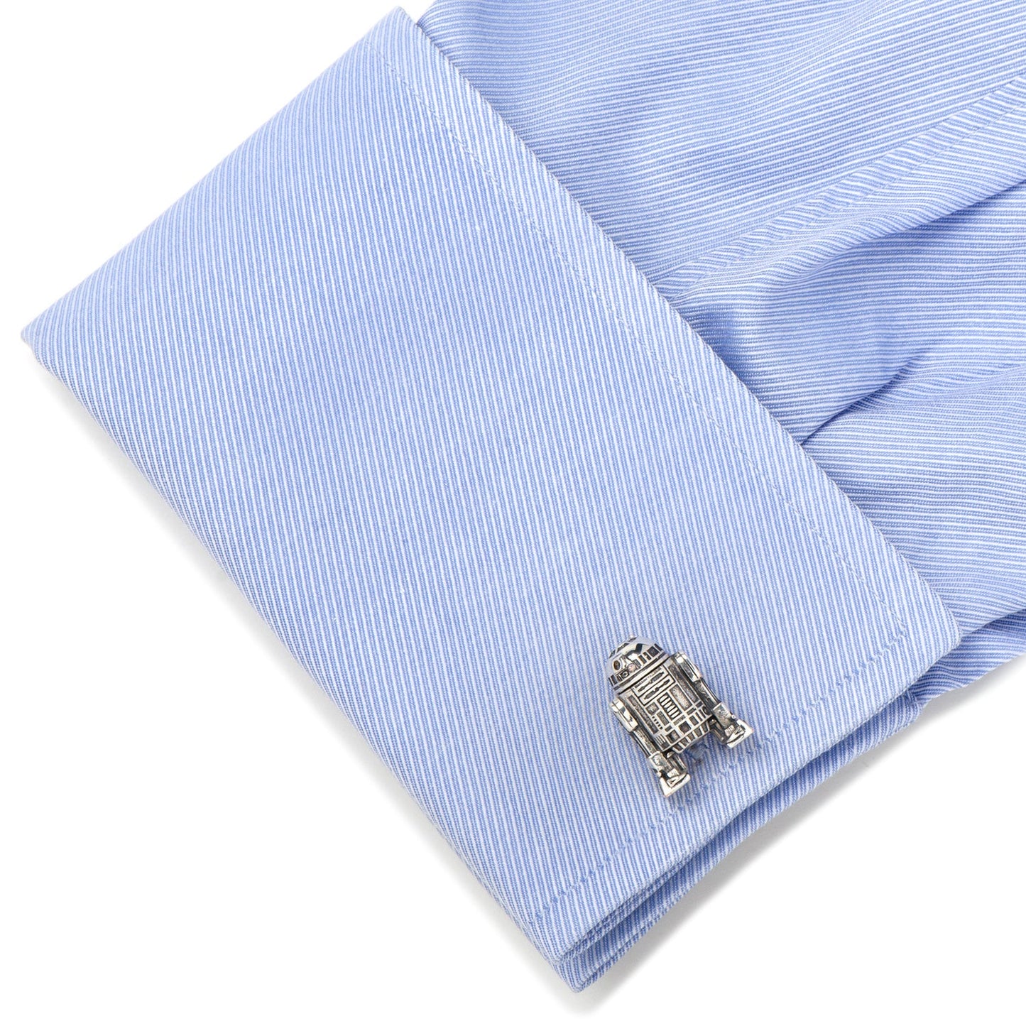 Silver robot cufflink on a light blue striped shirt