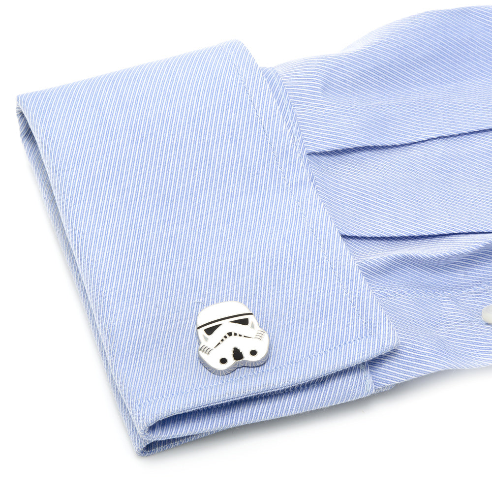 Stormtrooper cufflink on a light blue striped fabric background
