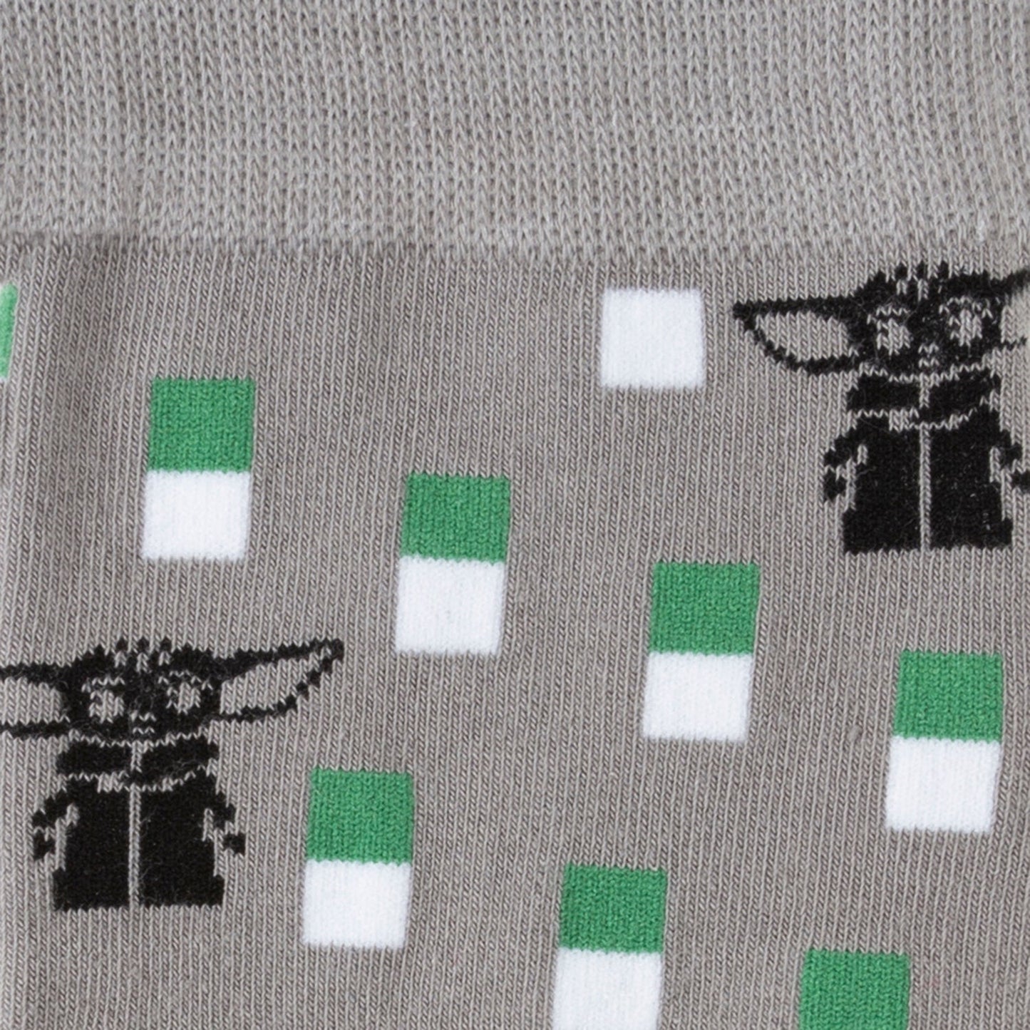 Gray sock with black and green designs of a character and colored squares.